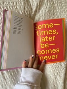 a woman's hand holding an open book with the title some times, later, be comes never