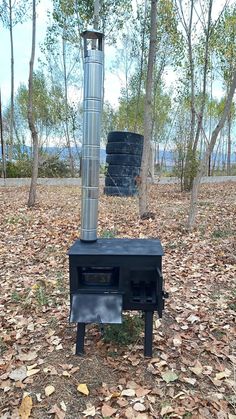 an outdoor stove in the middle of leaves