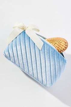 Softly quilted with a playful ribbon on the side, this cosmetic bag is as stylish as it is practical. | Quilted Velvet Cosmetic Bag by Anthropologie in Blue, Polyester/Spandex Cos Bags, Storing Makeup, Cute Makeup Bags, Pantone Colour Palettes, Quilted Velvet, Fancy Gifts, Cute Makeup, Pantone Color, Beauty Essentials