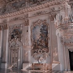 an ornately decorated room with chandeliers and paintings