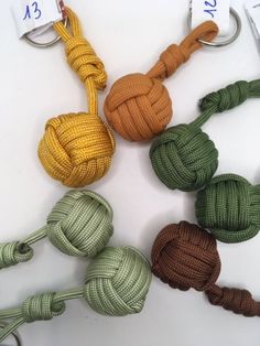 several different colored ropes are tied to each other on a white surface with numbered tags