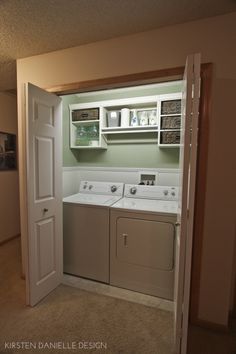 an empty washer and dryer in a small room with open doors to another room