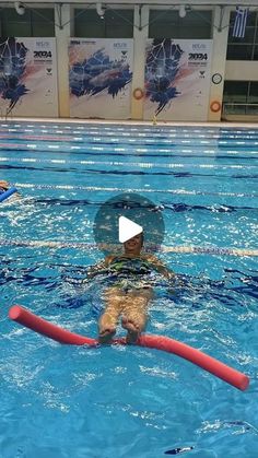 two people in a swimming pool, one with a life preserver on his back