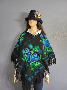 This gorgeous Mexican Artisanal Poncho is perfect for the cold months ahead! The multicolor Ethnic design adds that perfect pop of color and style to your wardrobe. This poncho is completely hand embroidered by cross stitch and handmade on a loom by Mexican Artisans in Puebla, Mexico. This poncho is knit, has open sides and it comes in one size so anyone ranging from size Small to Extra Large will be able to wear it. Traditional Fringe Poncho One Size, Winter Festival Embroidered Poncho, Traditional Long Sleeve Embroidered Poncho, Bohemian Long Sleeve Embroidered Poncho, Winter Embroidered Long Sleeve Poncho, Folk Style Festival Poncho One Size, Traditional Embroidered Poncho For Winter, Traditional Embroidered Winter Poncho, One Size Embroidered Poncho For Fall