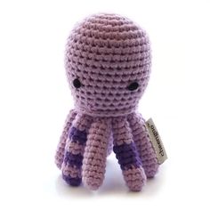 a crocheted octopus stuffed animal with a tag on it's chest and eyes