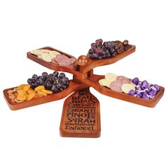 four wooden trays filled with different types of fruits and nuts on top of each other