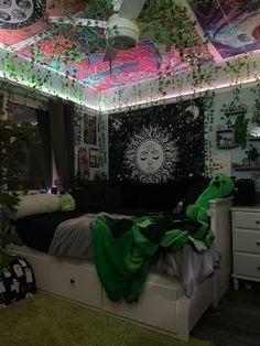 a bedroom decorated in green and white with lots of decorations on the ceiling, walls and ceiling fan