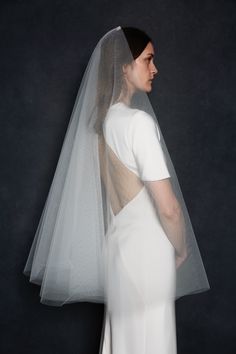 the back of a woman wearing a wedding veil