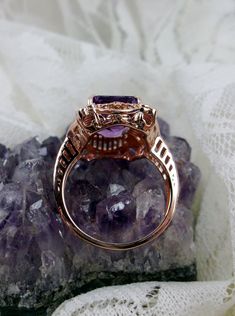 Natural Purple Amethyst Rose Gold plated Sterling Silver RingPicture Frame Design#D227 Inspired by Victorian era designs, this is a lovely reproduction ring. This lovely filigree handcrafted sterling silver ring is overlaid with rose gold plating. This flawless 5 carat Natural Purple Amethyst is 11mm x 9mm. The ring is 11/16" (17.5mm) North to South on the finger. The inside of the band is marked 925 for sterling silver. Notice the beautiful daisies on the outside of the setting and band. There Intricate Rose Gold Sterling Silver Jewelry, Classic Amethyst Rose Gold Jewelry, Fine Jewelry Amethyst Ring With Intricate Design, Fine Jewelry In Rose Gold With Amethyst, Amethyst Rings With Intricate Design For Wedding, Classic Rose Gold Amethyst Jewelry, Formal Rose Gold Amethyst Ring With Center Stone, Rose Gold Amethyst Fine Jewelry, Luxury Rose Gold Amethyst Ring As Gift