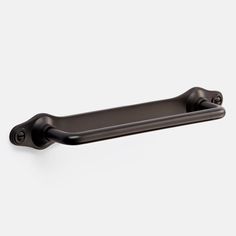 a black cabinet handle on a white wall