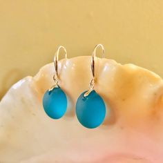 "These beautiful sea glass drop earrings are made from two pieces of .6-inch smooth, deep turquoise sea glass, adorned with an elegant sterling silver earring hook. Both hooks and bails are made from solid .925 sterling silver. Come visit my Earring Section for sea glass earrings in other colors and styles! https://www.etsy.com/shop/PendantsForACause?section_id=27147426 ---------- PACKAGING ---------- 🎁 Each handmade piece comes in its own beautiful, velvet-lined jewelry box and is ready to giv Beach Glass Jewelry, Deep Turquoise, Earrings Beach, Glass Drop Earrings, Beachglass Jewelry, Sea Glass Earrings, Beautiful Sea, Sea Glass Jewelry, Wire Earrings