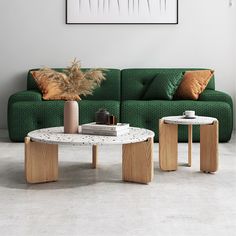 a living room with green couch and two tables