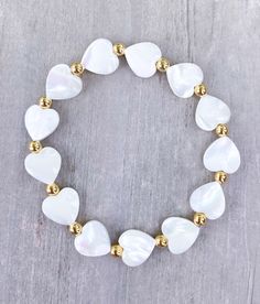 Natural White Shell Heart Bracelet 🤍 4mm 18k Gold Balls with 10mm white shell hearts The cutest layering piece ✨  CARING TIPS FOR YOUR JEWELRY ⭐️Treat and store with care. ⭐️ For longevity, avoid exposing your jewelry to water. ⭐️ Avoid having direct contact with lotions, perfumes, sanitizers as these chemicals may cause discoloration of your jewelry. White Bracelet With Heart Beads, White Heart Beads Bracelet For Weddings, White Heart Charm Bracelet For Anniversary, White Beaded Bracelets For Wedding On Valentine's Day, White Pearl Wedding Bracelet, White Bracelets With Heart Charm For Anniversary, White Heart Bracelet For Wedding, White Wedding Bracelets, White Heart Beads Jewelry For Valentine's Day