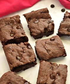 chocolate brownies cut into squares on a white plate