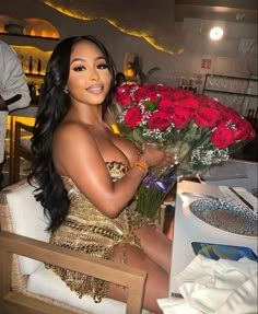 a woman sitting in a chair holding flowers