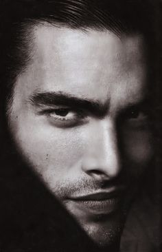 a man with long hair is posing for a magazine cover photo in black and white