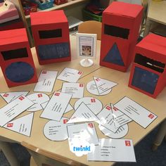 some red boxes sitting on top of a table next to cards and papers that say i love you