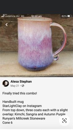 a purple and pink mug sitting on top of a wooden table