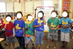 several children wearing masks with rubber ducks on their faces and holding up signs in front of them