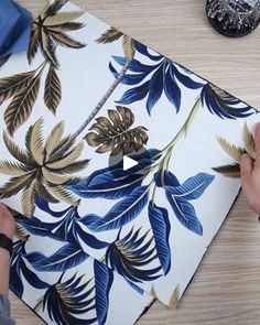 a person is cutting paper with scissors on a table next to some other items and decorations