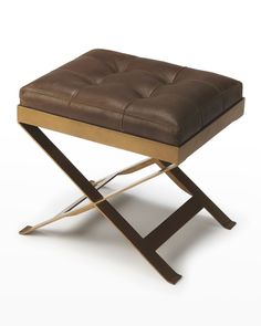 a brown leather stool with metal legs and a wooden seat on the bottom, sitting in front of a white background