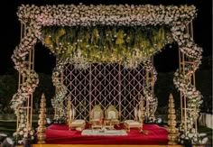 a decorated stage with white flowers and greenery