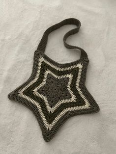 a black and white crocheted bag with a star on it