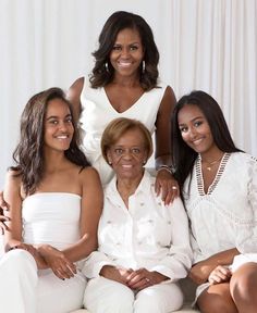 the first lady and her daughters are posing for a family photo in their white outfits