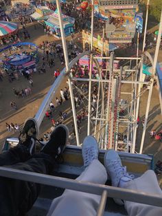 someone is sitting on the edge of a carnival ride