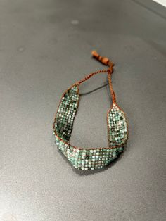 a beaded bracelet is sitting on a table