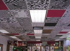 the ceiling in an office is decorated with black, white and red designs on it