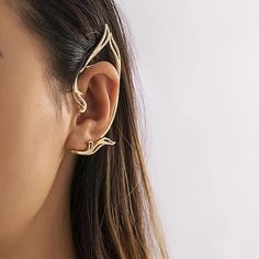 a close up of a person wearing a pair of ear piercings on their ears