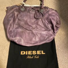 Nwt Diesel Black Gold Collection. Super Soft Leather, Very Large And Can Hold Lots Of Stuffs Designer Hobo Bag With Top Carry Handle, Designer Satchel Shoulder Bag With Rolled Handles, Designer Shoulder Bag With Rolled Handles, Designer Satchel With Rolled Handles, Designer Shoulder Satchel With Rolled Handles, Designer Purple Satchel For Shopping, Purple Designer Shoulder Bag, Designer Purple Double Handle Shoulder Bag, Designer Purple Bags With Handles