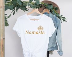 Introducing our Namaste Yoga T-shirt, a garment that truly embodies the essence of yoga and meditation. Crafted with love and intention, this tee is a harmonious blend of comfort and style, designed to elevate your practice and your wardrobe. ️ Made from the softest 100% Airlume combed and ring-spun cotton, our Namaste Yoga T-shirt caresses your skin with every movement, making it feel like a gentle hug from the universe. It's not just any T-shirt; it's your new Comphy Meditation essential. The White Crew Neck Top For Meditation, White T-shirt For Yoga In Summer, White T-shirt For Yoga And Summer, White Summer Yoga T-shirt, White Relaxed Fit Yoga T-shirt, White Relaxed Fit T-shirt For Yoga, Tree Circle, Yoga Lotus, Yoga Namaste