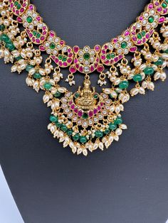 Jadau Kundan Goddess Lakshmi Short Neckline Necklace with Emerald Beads with matching JhumkasColor : GoldenSize : Necklae Length : 14 Inches; No EarringsStones : Jadau Kundan Red Green Clear Jadau Kundan Emerald Beads Kundan Temple Necklace With Latkans, Heavy Chandbali Pearl Necklace For Diwali, Kundan Pearl Necklace For Festivals, Temple Style, Diwali Temple Jewelry Pearl Necklace With Tilla, Diwali Rituals Chandbali Necklaces, Festive Temple Jewelry Bridal Necklace With Latkans, Festive Temple Bridal Necklace With Latkans, Kundan Temple Jewelry Necklaces For Navratri, Chandbali Necklaces For Diwali Rituals