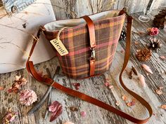 Two interior pockets, leather detachable adjustable crossbody strap, leather closure. This seamless and itricate tartan plaid is woven into the fabric and is just perfect for those crisp walks in the autumn air. Dimension: About 8.00'W"x8.00"H"x5.50"D Fall Plaid Rectangular Shoulder Bag, Fall Leather Trim Crossbody Shoulder Bag, Plaid Bags For Everyday Use In Fall, Fall Bags With Leather Trim, Fall Bucket Shoulder Bag With Leather Handles, Fall Travel Shoulder Bag With Leather Trim, Fall Shoulder Bag With Leather Trim, Crossbody Shape, Fall Shoulder Bag With Leather Trim, Fall Travel Shoulder Bag With Adjustable Strap