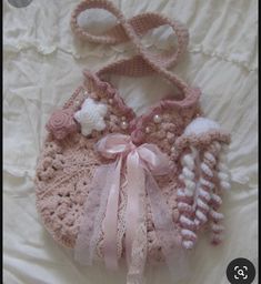 a crocheted baby bib and booties laying on a bed