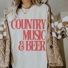 Product Title: Country Music and Beer Comfort Colors Shirt - Festival Ready, Western Music Tee Product Description: Celebrate your love for country music and cold beer with our "Country Music and Beer" Comfort Colors Shirt. Perfect for concerts, festivals, or a casual day out, this soft and durable tee is a must-have for any country music fan. Crafted from premium 100% cotton, it offers a relaxed fit and vintage-inspired feel that gets softer with every wash. Features: Design: Bold "Country Musi Country Tshirt Designs, Beer Graphic, Country Music Festival, Festival Shirt, Western Music, Music Tees, Western Look, Festival Shirts, Cold Beer