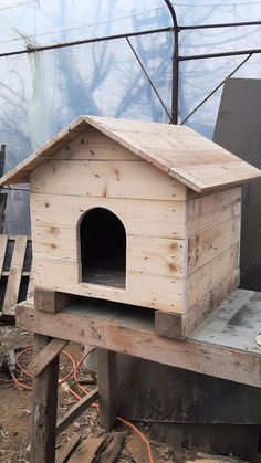 a wooden dog house sitting on top of a table