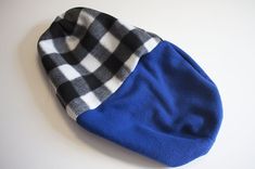 a blue and white plaid hat sitting on top of a table