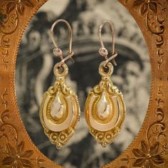 This stunning pair of 9ct gold Etruscan Revival antique drop earrings date to the Victorian period. They are beautifully carved with hints of a horseshoe shape in each for good luck, and hang daintily from the ear for a truly charming, classic look. Etruscan revival jewellery, which emerged in the late Georgian period, and took root in Victorian Britain during the archaeological craze. New technology permitted jewellers to work their materials in ways never seen before, and these pieces were cha Antique Gold Earrings With Historical Design, Antique Historical Drop Earrings, Antique Jewelry With Historical Design Drop Earrings, Antique Gold Victorian Drop Earrings, Antique Jewelry Drop Earrings With Historical Design, Antique Oval Brass Earrings, Victorian Engraved Yellow Gold Earrings, Victorian Style Engraved Yellow Gold Earrings, Antique Brass Oval Earrings