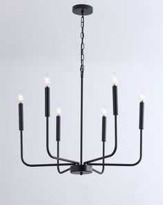 a black chandelier with six candles hanging from it