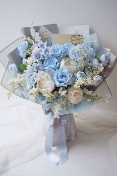 a bouquet of blue and white flowers on display