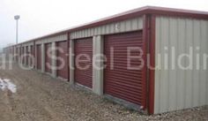 a row of storage units sitting next to each other on top of a dirt field