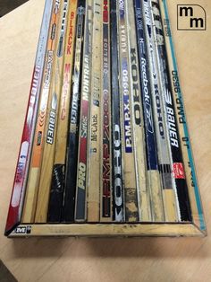 a bunch of cds sitting on top of a wooden table