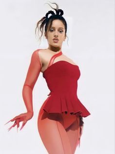 a woman in a red dress with her hands on her hips, posing for the camera