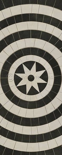 an abstract black and white tile design with circular tiles in the center, as well as a star