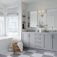 a bathroom with a checkered floor and white walls, along with a large bathtub