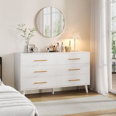 a bedroom with a bed, dresser and mirror