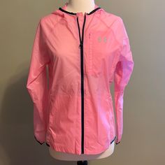 This Jacket Is Brand New With Tags And Has Never Been Worn. This Under Armour Jacket Is A Women’s Size Small. This Jacket Is A Pretty Bright Light Pink. It Is Lightweight And Has A Translucent Look. This Jacket Zips Up The Front, Has A Front Zipper Pocket, Elastic Cuffs, Side Pockets And A Hood. The Jacket Is Water Repellent And The Material Is 100% Nylon. It Is 19” From Armpit To Armpit, 24.5” From The Shoulder To Bottom And Has A Relaxed Fit. Message Me With Questions! Casual Under Armour Windbreaker For Outdoor Activities, Pink Nylon Windbreaker For Outdoor Activities, Pink Windbreaker For Outdoor Fall Activities, Pink Sporty Windbreaker For Outdoor Activities, Sporty Pink Windbreaker For Outdoor Activities, Pink Spring Outerwear For Outdoor Activities, Pink Athleisure Outerwear For Sports, Casual Under Armour Windbreaker For Outdoor, Pink Windbreaker For Outdoor Activities With Pockets